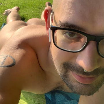 My selfie, lying on my belly on a nude beach, in the frame visible my face and ass